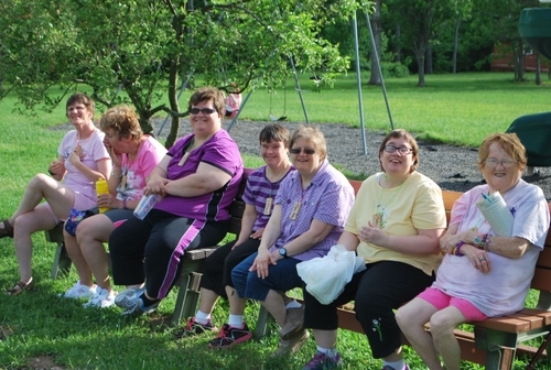 Our exceptional campers sitting on a bench enjoying each others company.